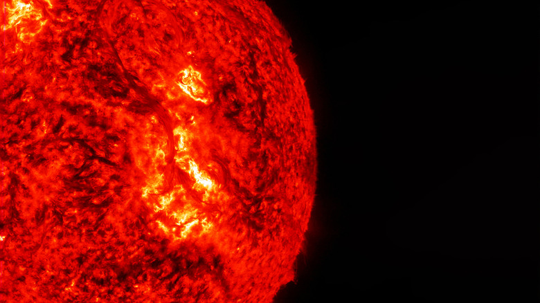 A solar storm on the surface of the sun against a black background