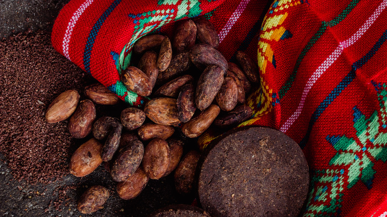 Cacoa beans and Mexican metate for grinding them