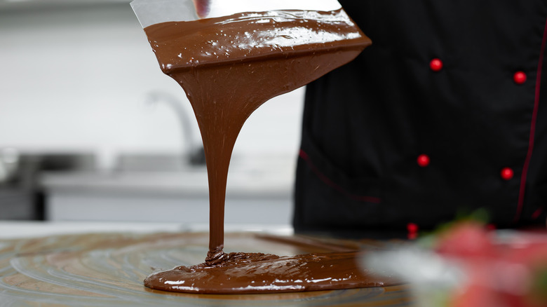 Chocolate being tempered with spatula