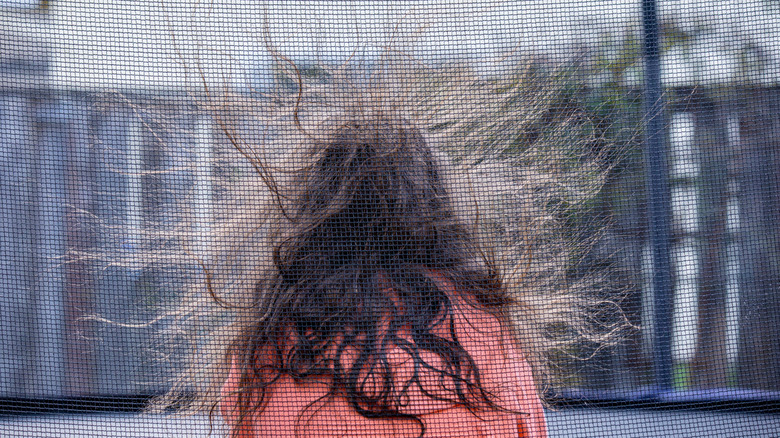 Girl's hair floating up because of static electricity