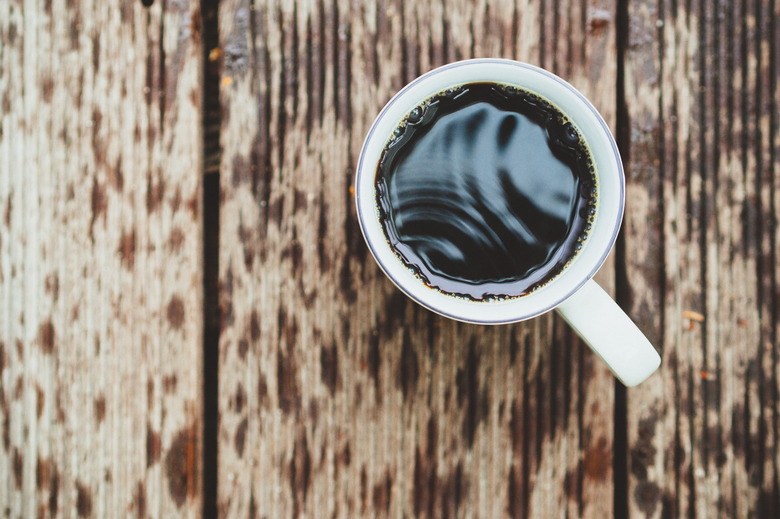 Directly Above Shot Of Black Coffee On Wet Table