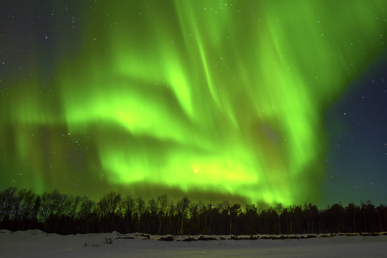 Northern Lights (Aurora borealis) over snowscape.