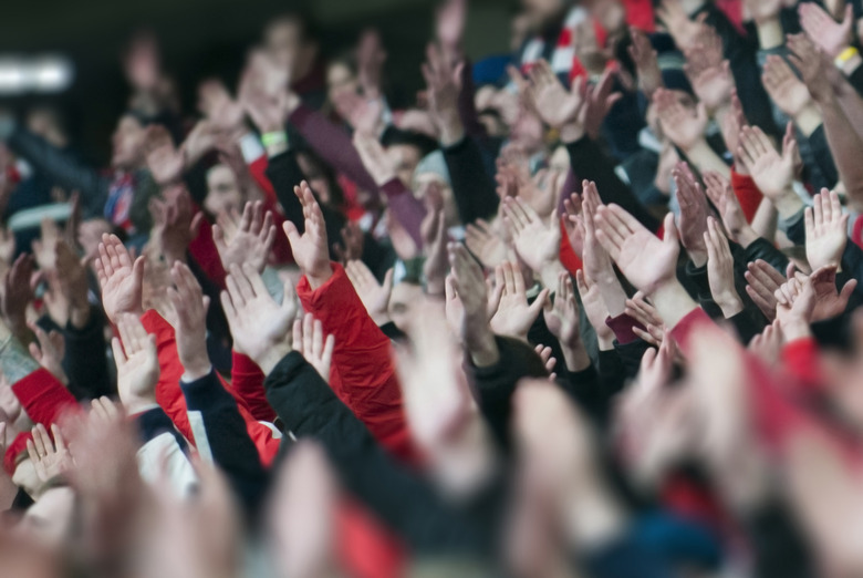 Football fans clapping on the podium of the stadium