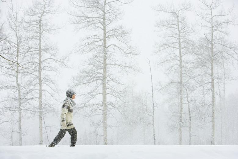 Mature woman walking in snow