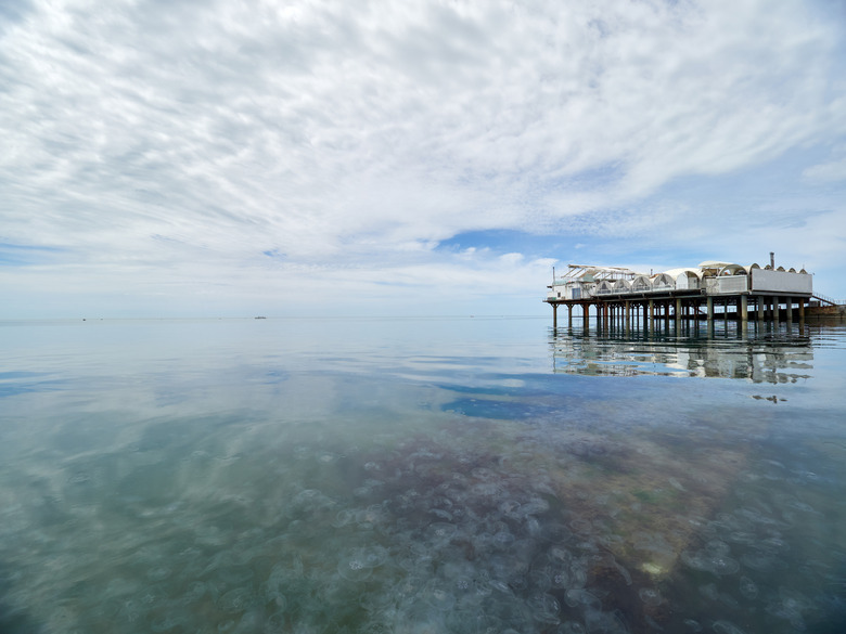 Platform on supports in the sea near the shore. Low dense clouds over the sea.