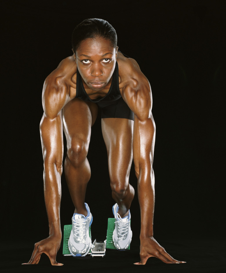 Front View of a Female Athlete Crouching in Starting Blocks