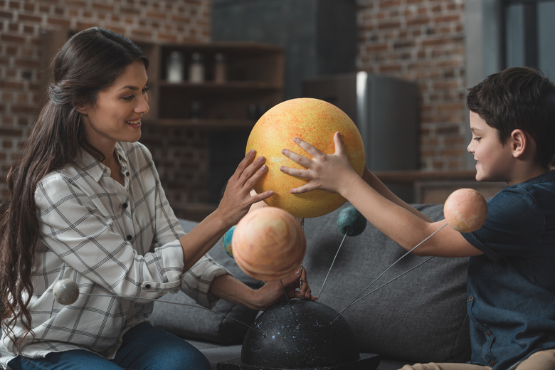 Mother and son assembling Galaxy model