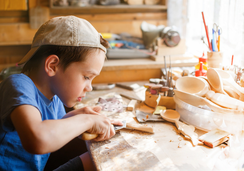 boy learning wood carving