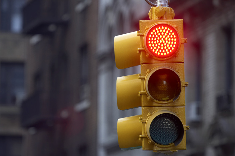 Traffic light on street with red signal lit up