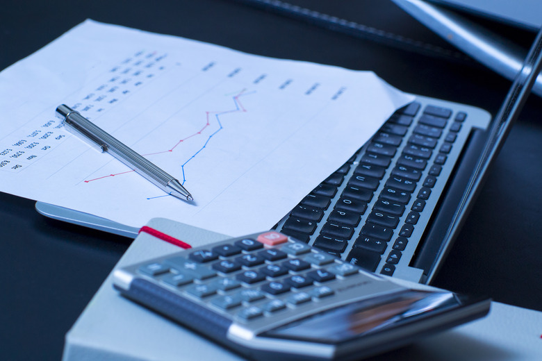 Businessman analyzing investment charts with laptop