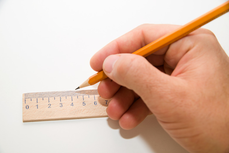 Men's right hand holding a pencil on over white