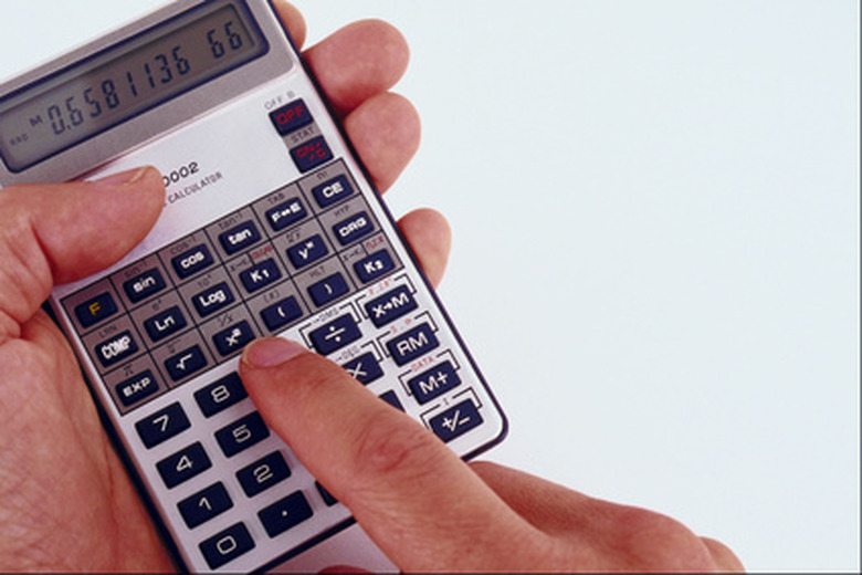 man's hand holding a calculator