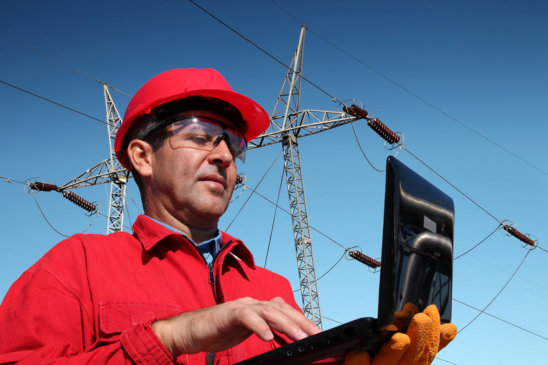 Engineer Using Laptop to calculate coulombs