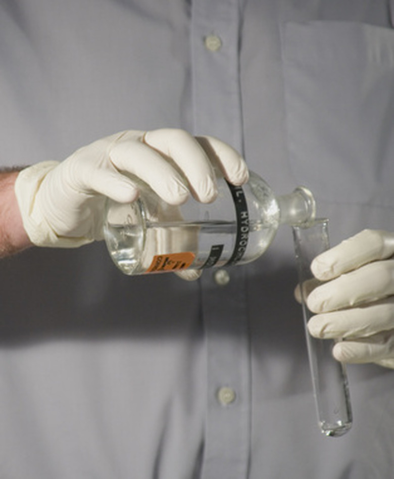 Pouring clear liquid into a test tube