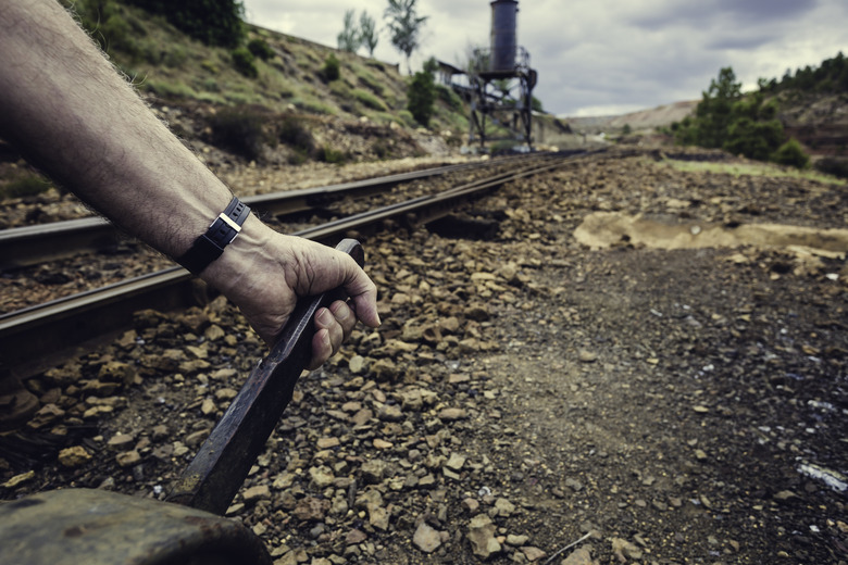 Hand pulling the lever to change the way in the old train station of Zaranda