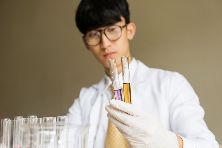 Scientist with chemical liquid on test tune