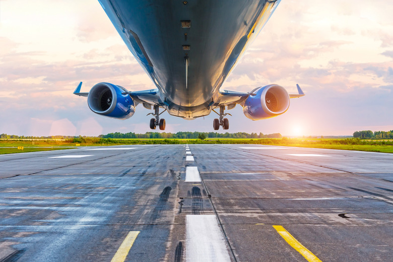 Airplane before landing, bottom view of engines and wings, wpp with lanshtafom before sunset