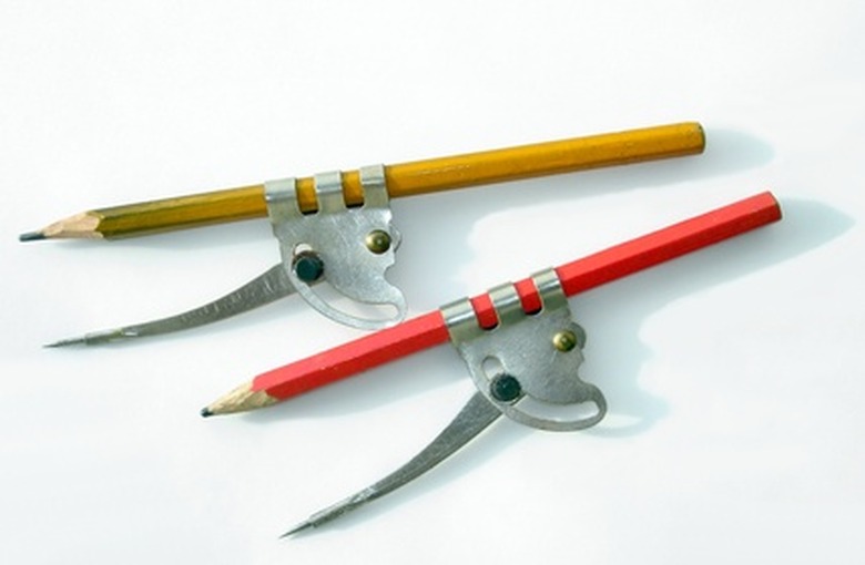 Two compasses with pencils.