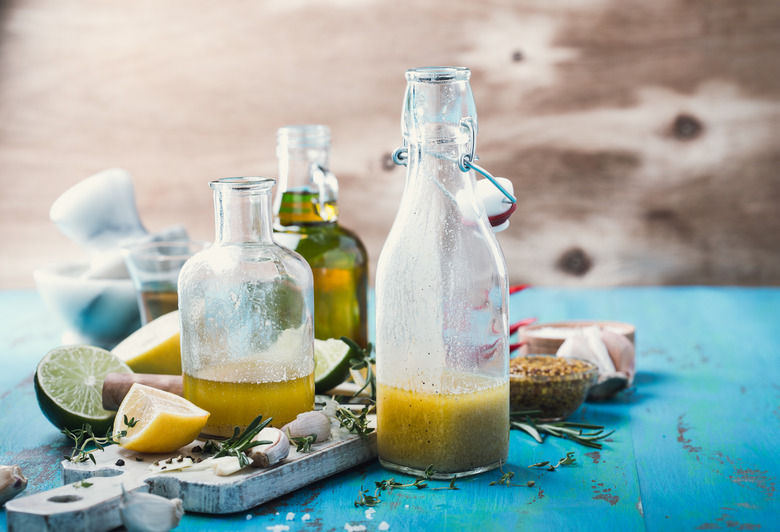 Limes and lemons and their juice in bottles on a table