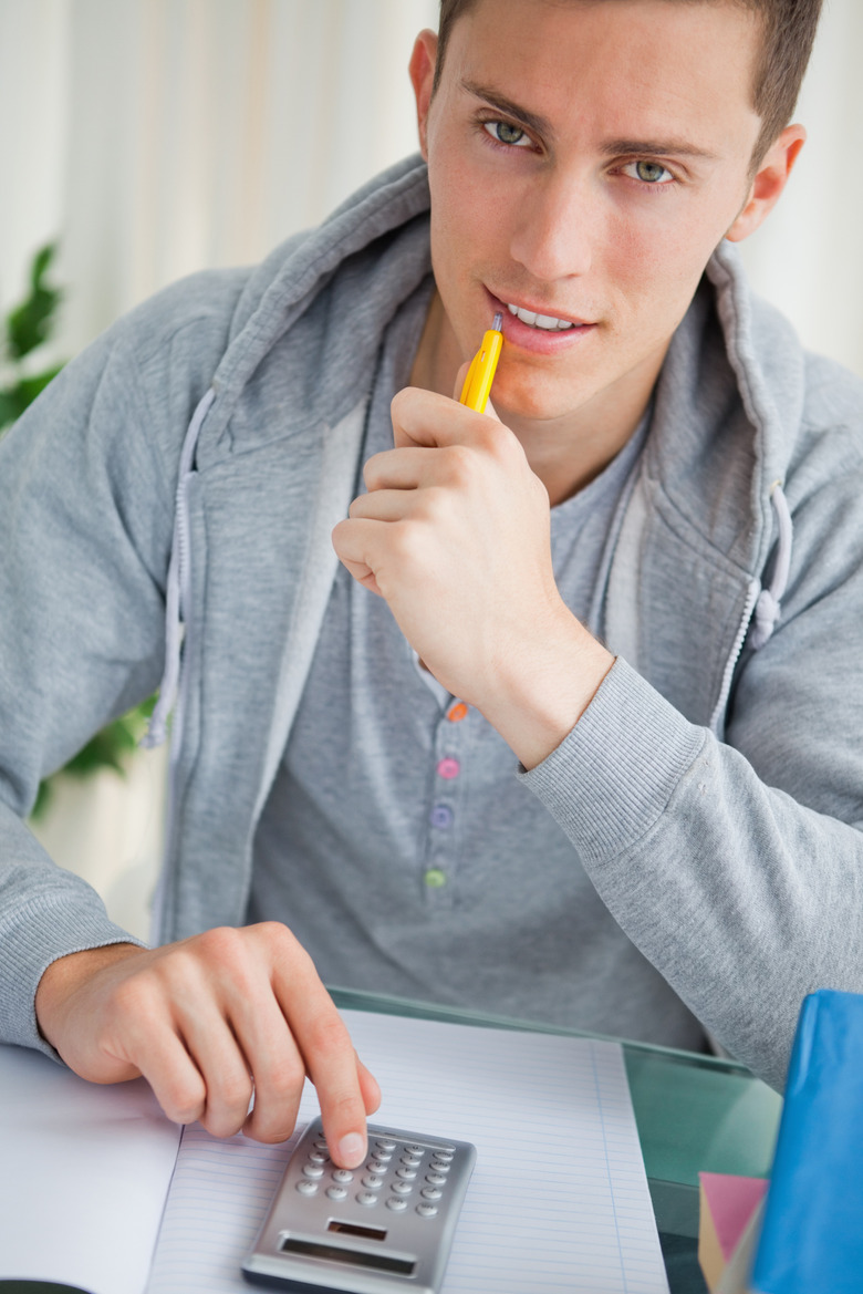 Handsome student using a calculator