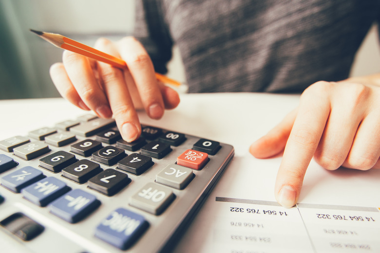 Closeup of Accountant Hands Counting on Calculator