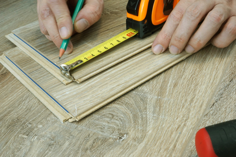 Man preparing for installation of laminate flooring. Renovation of floor.