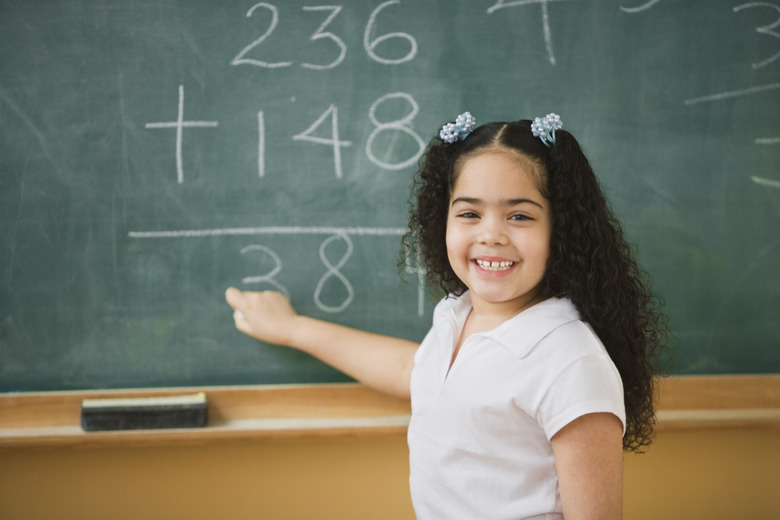 Student doing mathematics on the chalkboard