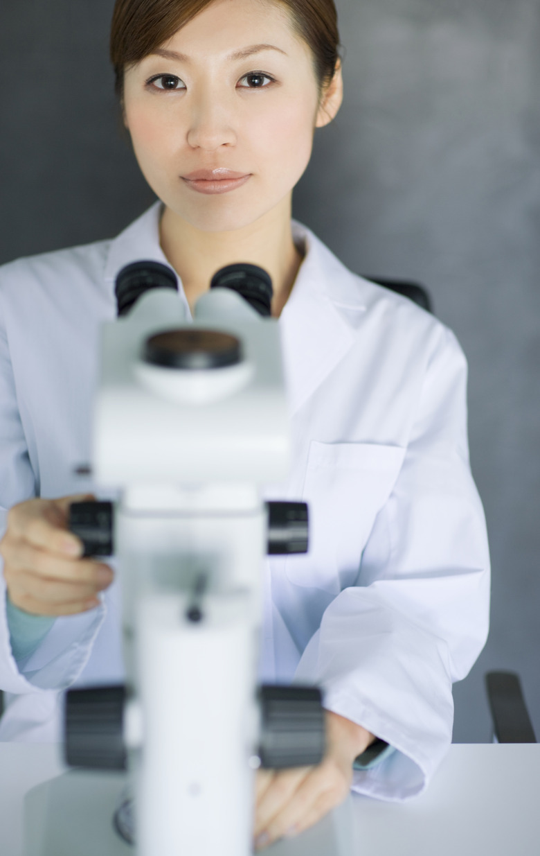 Woman looking through microscope