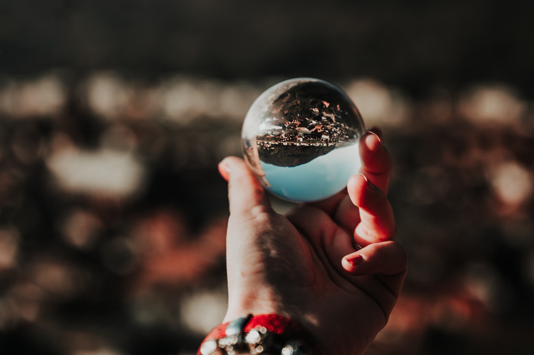 Cropped Hand Holding Crystal Sphere