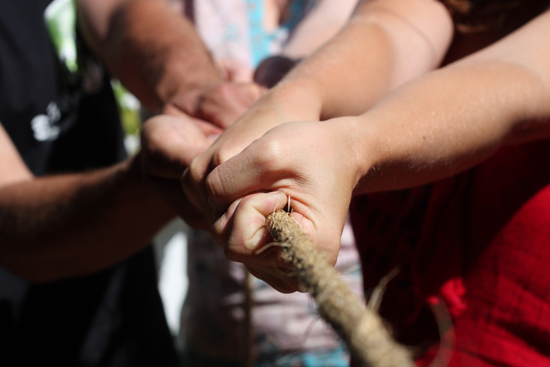 Close up of hands pulling a rope in tug of war