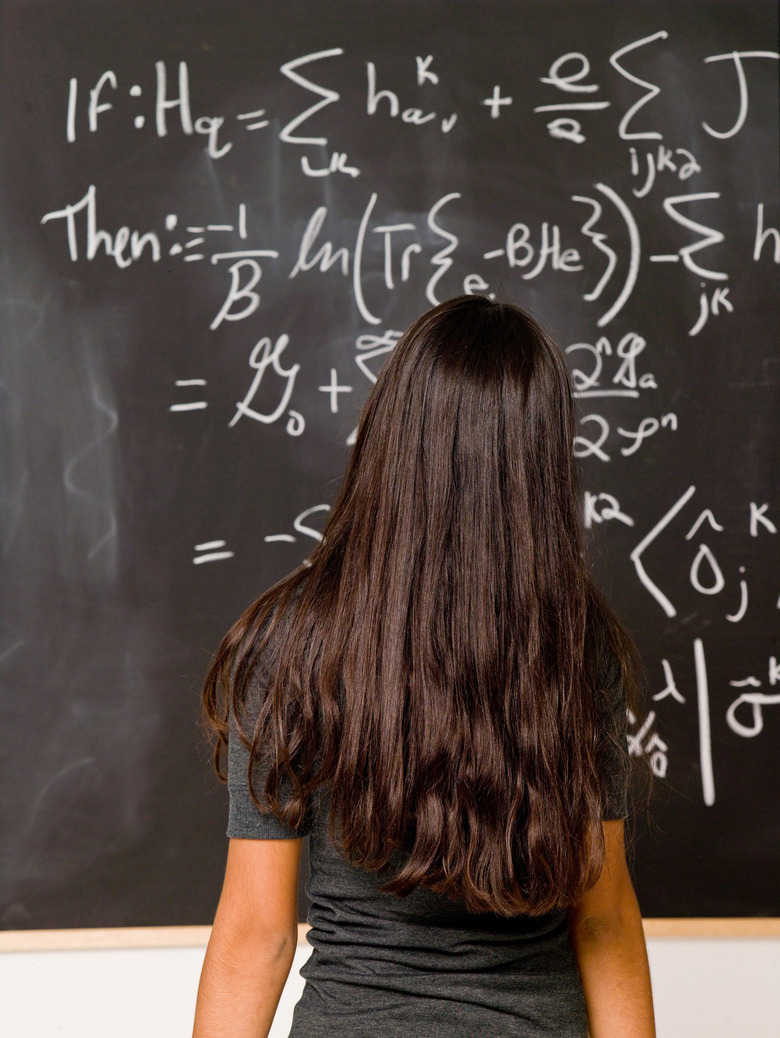 Back view of student at blackboard with math equations