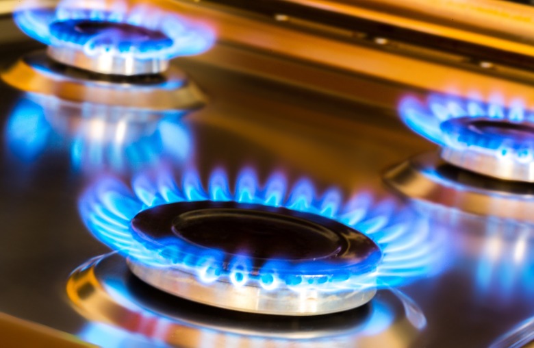 A blue flame emanating from gas stove burners