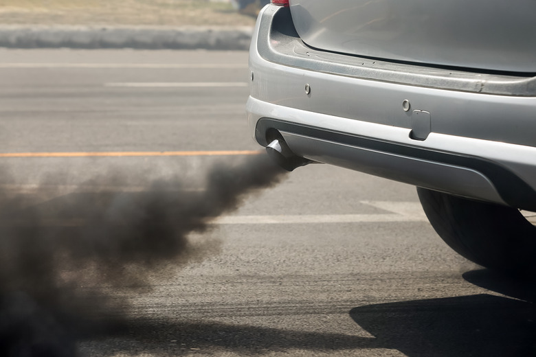 Air pollution from vehicle exhaust pipe on road