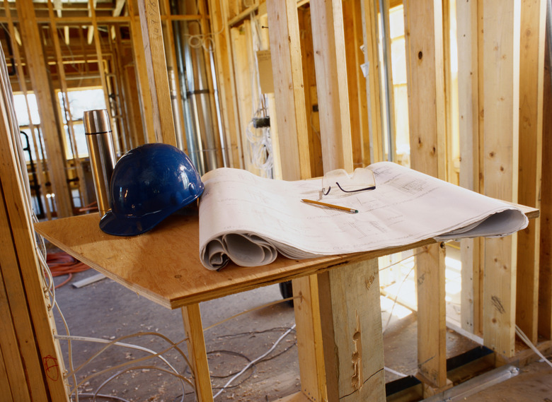 Blueprint and a Hard Hat Inside a Building Frame