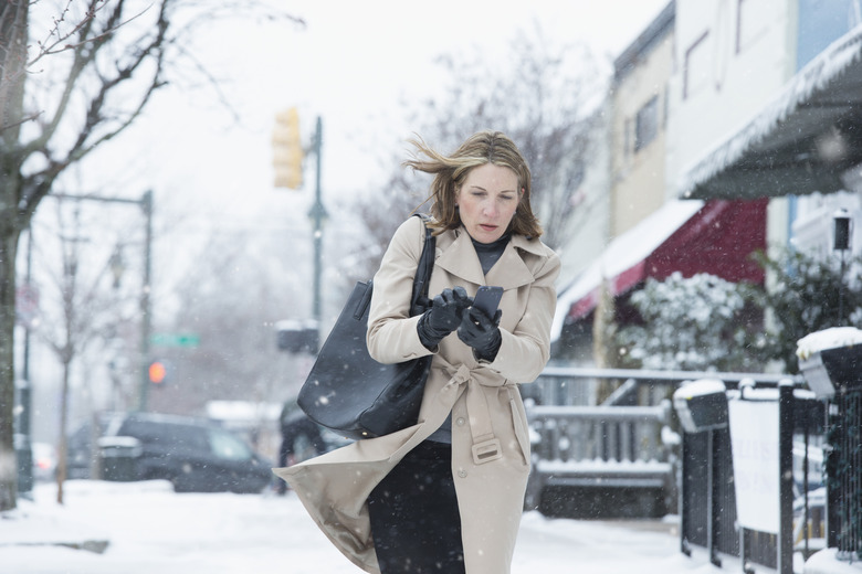 Woman walking on snowy street