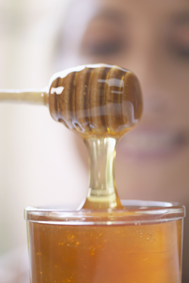 Fresh honey dripping from dipper