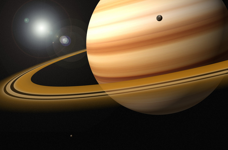 Saturn, Glowing Stars and a Moon of Saturn