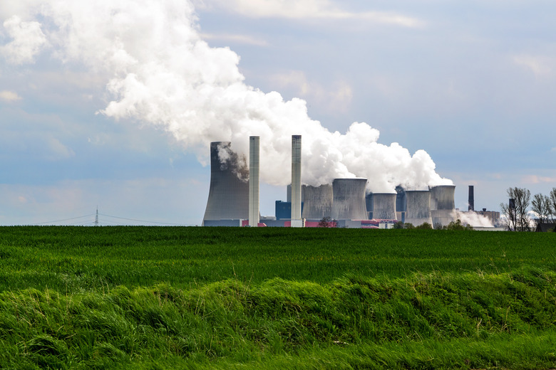 lignite fired power station behind a green agricultural landscape