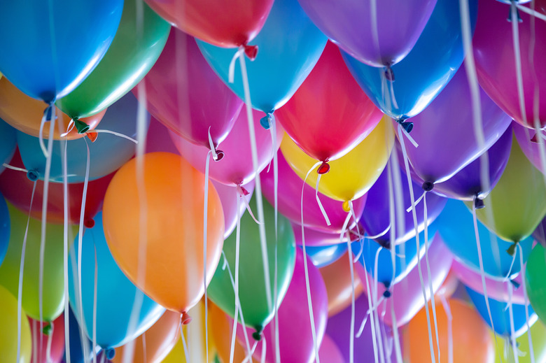 festive, colorful balloons with helium attachment to the white ribbons