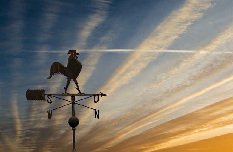 Silhouette of weather vane with decorative metallic rooster