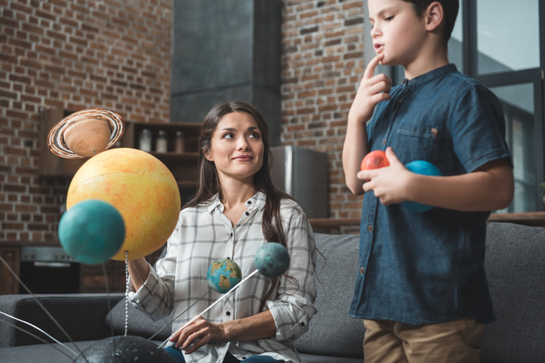 Mother and son assembling Galaxy model