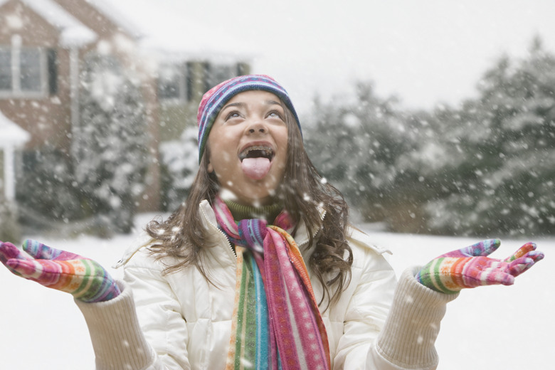 Mixed race girl with mouth open in snow