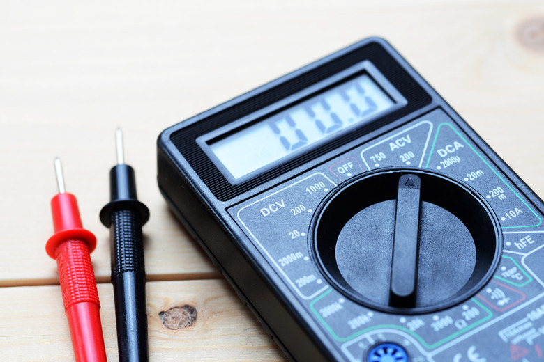 multimeter lies on a wooden board