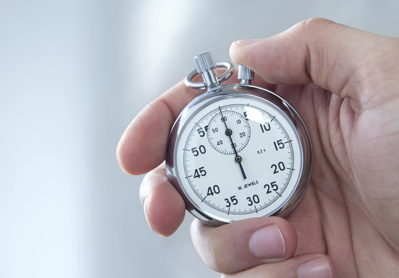 Male hand holding stopwatch