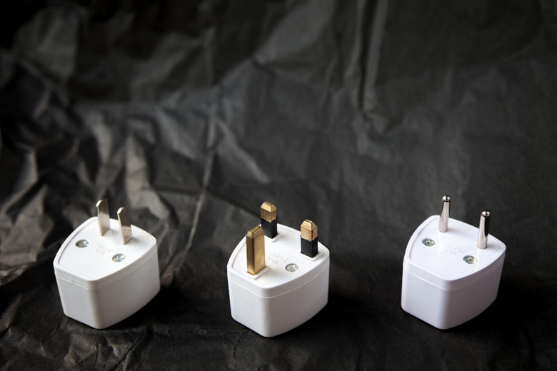 Choosing from various electric plug adapters. Convert appliances from 220 to 110