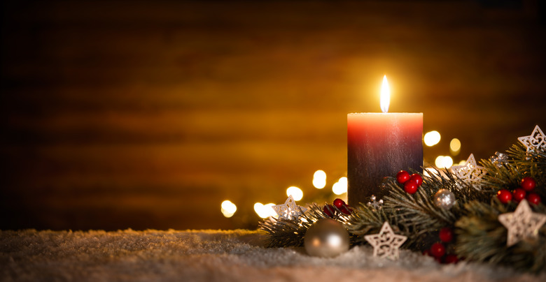 Candle and Christmas decoration with wooden background