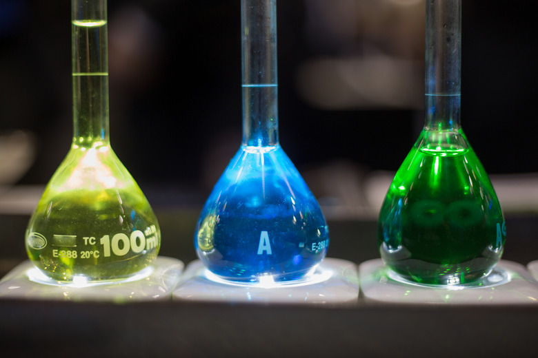 Three flasks filled with yellow, blue and green liquid