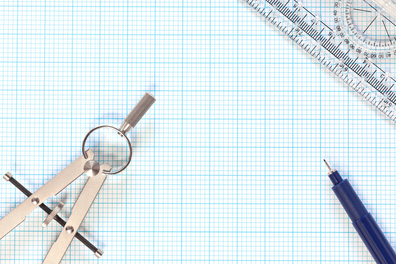 Engineering graph paper and compass still life