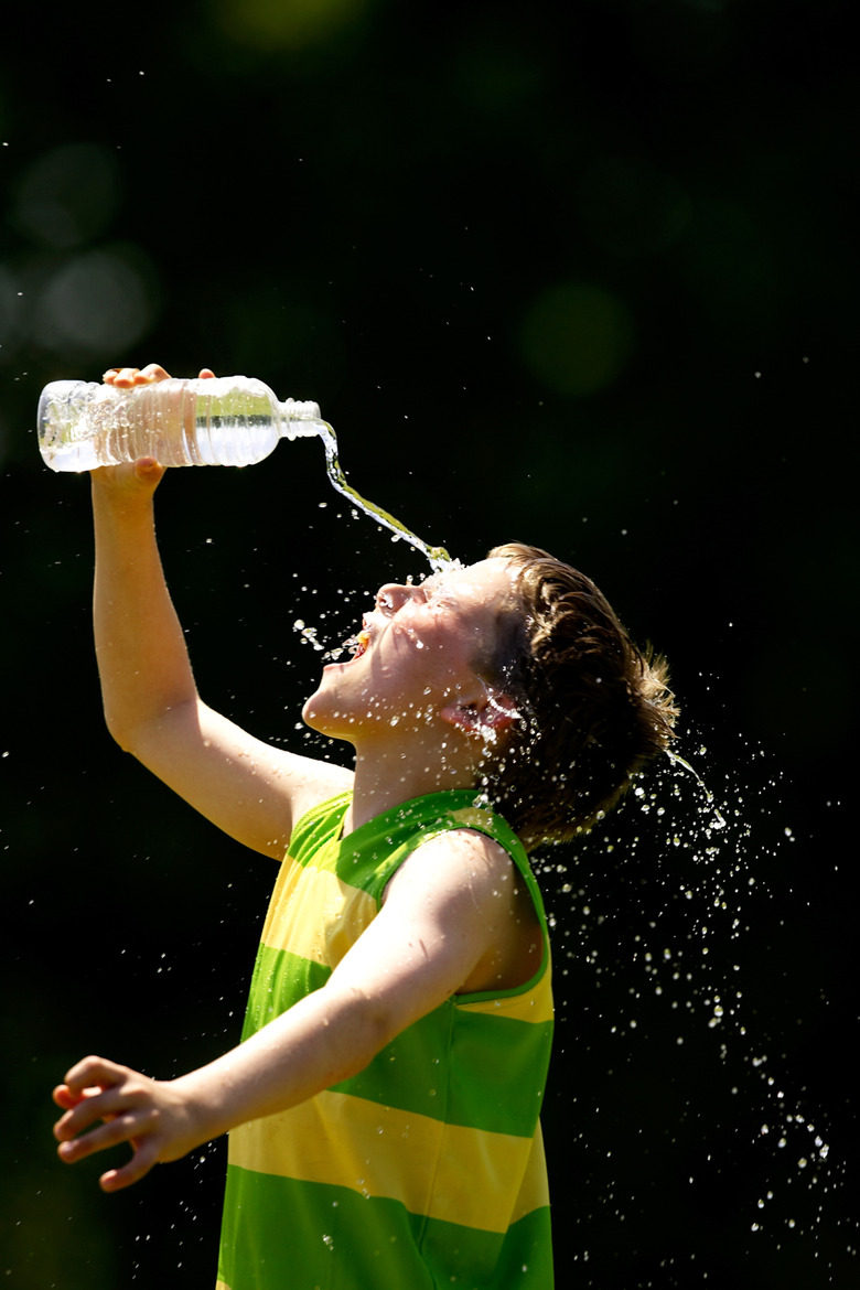 Young player splashes water on his face