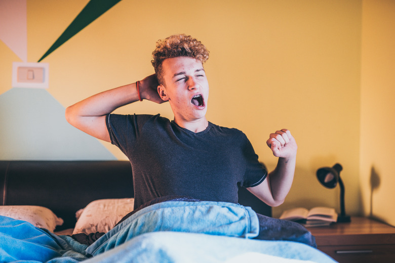 Teenage Boy Waking up in the Morning Yawning